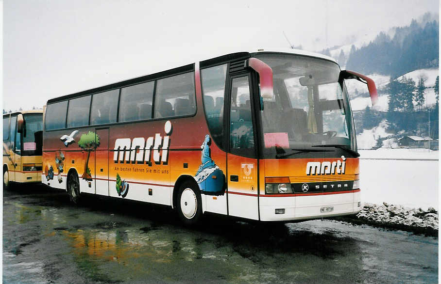 (039'105) - Marti, Kallnach - Nr. 8/NE 98'718 - Setra am 19. Februar 2000 in Frutigen, Flugplatz