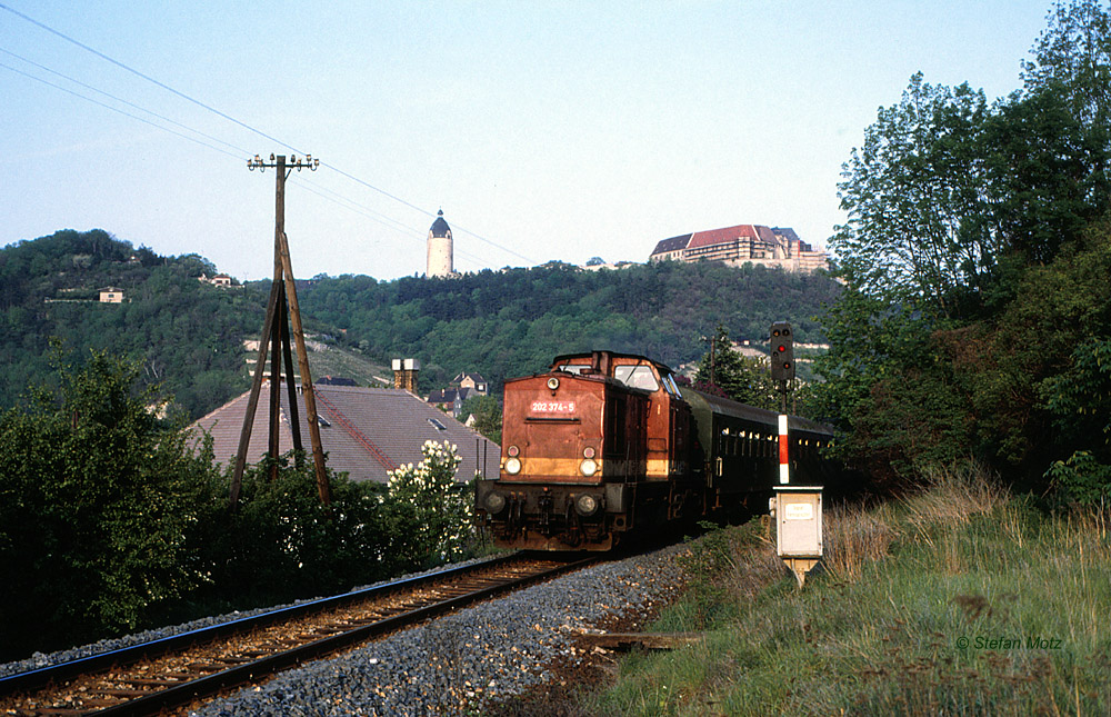 Am 14.05.1992 war die DB 202 374-5 mit einem Personenzug aus Naumburg Hbf Richtung Nebra im Unstruttal bei Freyburg unterwegs. Im Hintergrund sieht man die Neuenburg und den  Dicken Wilhelm . (Foto: Stefan Motz)
