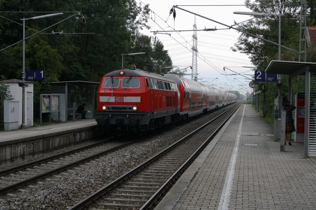 Unter weigrau-regnerischem Himmel eilt die Sandwich-Traktion mit 8 Doppelstockwagen und 218 440-6 und 422-4 am 02.09.11 mit viel Krawall durch Grub Richtung Mnchen.