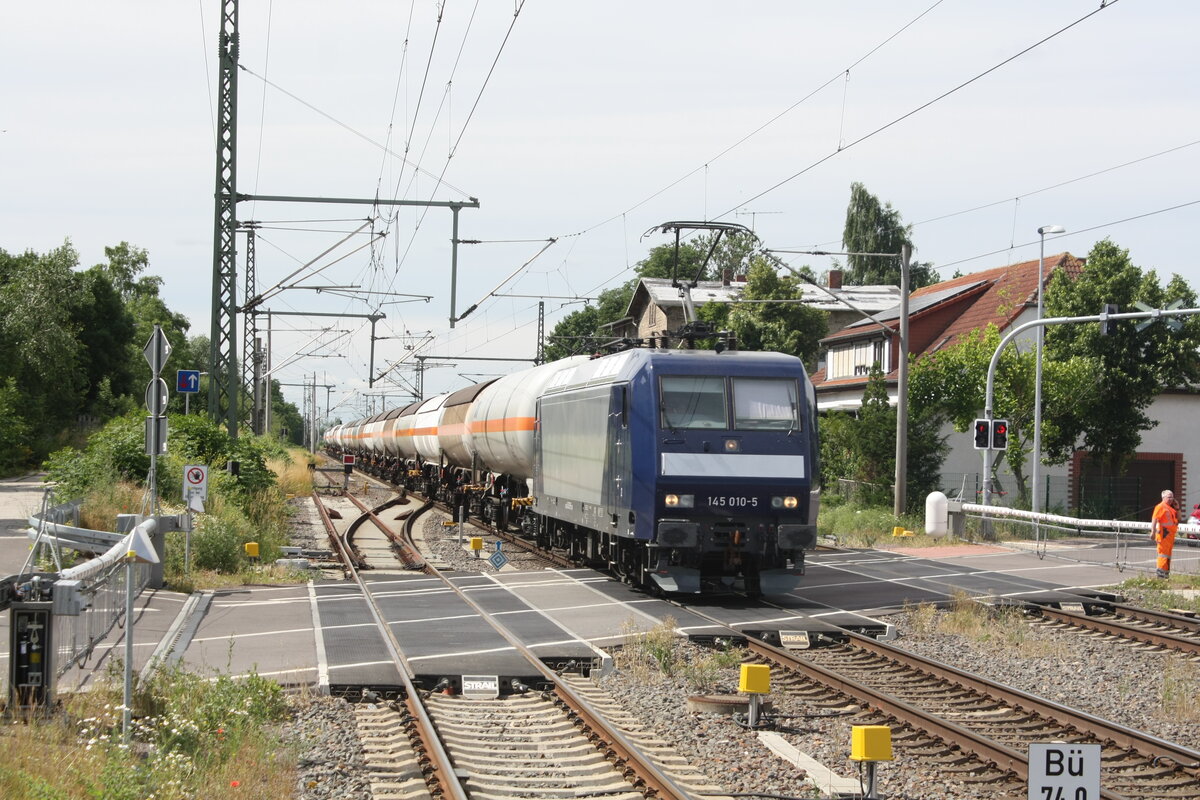 145 010 mit einem Kesselzug bei der Durchfahrt im Bahnhof Niemberg am 5.7.21