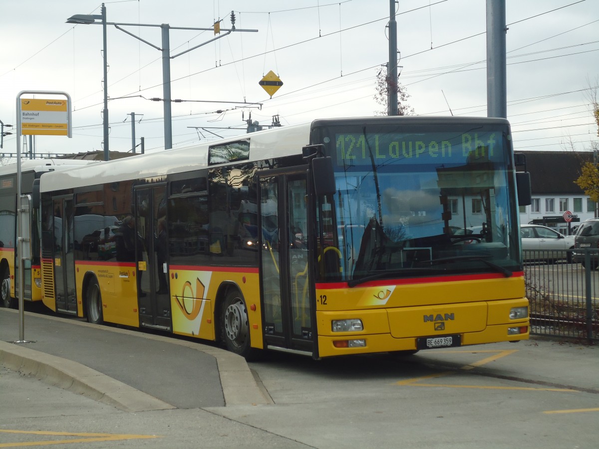 (148'167) - Klopfstein, Laupen - Nr. 12/BE 669'359 - MAN (ex STB Laupen Nr. 32) am 25. November 2013 beim Bahnhof Ddingen