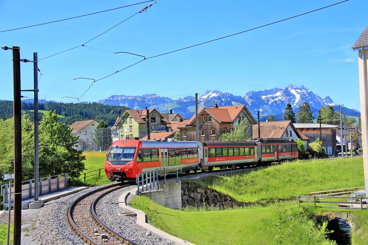 Appenzellerbahnen - Einfahrt in Gais. Zug mit Triebwagen 12 und dem neuen Steuerwagen 121 (bei dem sich die Fenster nicht öffnen lassen, so dass nur Bilder voller grässlicher Spiegelungen gemacht werden können). 10.Juni 2016. 