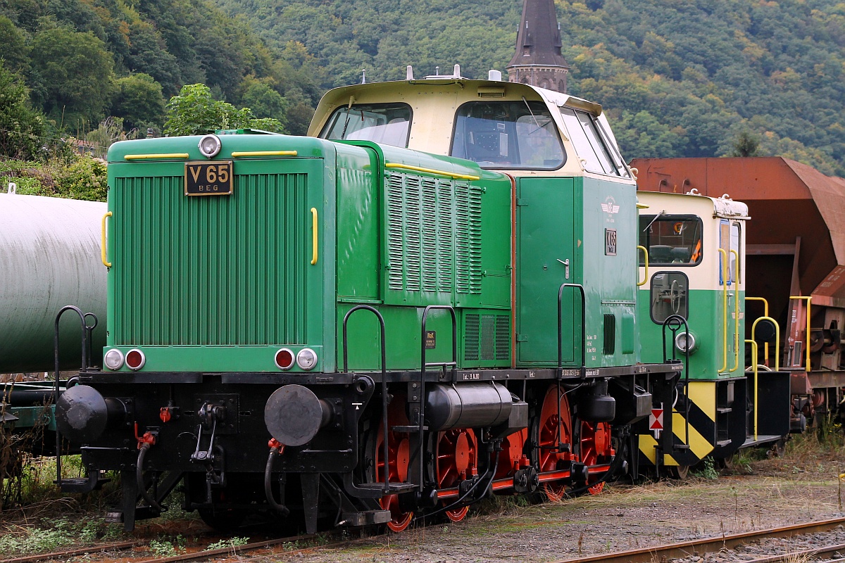 BEG V 65 (MaK 600D, 9880 3265 202-2)hat eine bewegende Geschichte die im Jahre 1958 mit der Auslieferung an die AEE(Ahaus-Enscheder Eisenbahn)als D 05 begann. Von 1967 bis 1999 war sie u.a tätig bei der TWE(Teutoburger Wald Eisenbahn), der BSE(Braunschweig-Schöninger Eisenbahn), der BTh(Eisenbahn Bremen-Thedinghausen), der BLE(Butzbach-Licher Eisenbahn), der NHS(Eisenbahn Neheim-Hüsten-Sundern), der JK(Jülicher Kreisbahn), der SWEG(Südwestdeutsche Eisenbahngesellschaft mbH) sowie der KKB (Kleinbahn Kaldenkirchen-Brüggen), dem British Army, RCT - Royal Corps of Transportation, der VEBEG in Frankfurt und bei Schreck Mieves in Frechen bevor sie 2008 von der BSBG(Brohltal-Schmalspureisenbahn Betriebsgesellschaft)übernommen wurde und dort bis heute  arbeitet . Im Jahre 2013 spendierte man ihr eine neue HU(29.04.13). Hier steht sie zusammen mit der D8(Jung RK8B)zusammen abgestellt in ihrem Heimatbahnhof in Brohl abgestellt und genießt das Wochenende. 15.09.2013