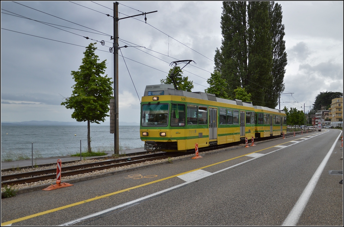 Besonders schön gelegen ist der übriggebliebene Rest der Neuenburger Tram entlang des Neuenburger Sees nach Boudry. Hochflurfahrzeug Be 4/4 506, Baujahr 1988, zwischen Serrieres und Neuenburg. Juni 2016. 