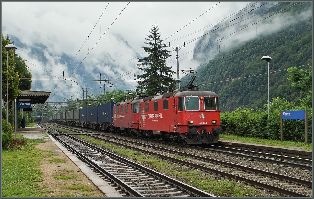 Crossrail Re 4/4 III (bzw. Re 436 112-7) mit einer Schwesterlok und einem langen Güterzug auf der Fahrt Richtung Norden bei der Durchfahrt in Varzo. 
2. Juli 2014