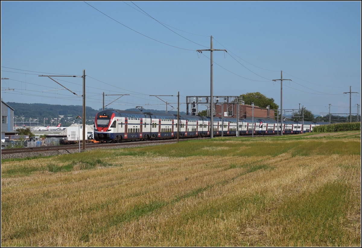 Kiss left und Kiss right, von den SBB als RVD bezeichnet, geben hier die Jumboversion einer S-Bahn ab. 1134 Sitzplätze und bei Bedarf 2746 vollbesetzt erklären, warum die S-Bahn Zürich ihren Bedarf decken kann. Zum Vergleich müsste eine Kölner oder Berlier S-Bahn gleich 3 Züge rollen lassen, was ein Gleis dort gleich 12 Minuten belegt. Eine Frankfurter oder Münchner S-Bahn bräuchte immerhin einen Langzug und einen Vollzug. RABe 511 056 und RABe 511 048 in Rümlang, September 2021.