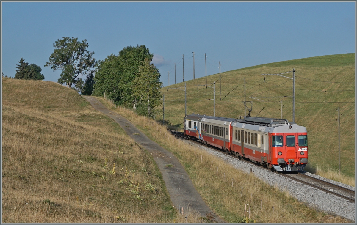 Noch ein letztes Mal vor dem Angebostswechsel am 7. Aug. wollte ich den  TRAVYS  Schülerzug fotografieren, leider war er bereits etwas  verkünstlert . Zumindest ein Teil des Geschiere habe ich entfernt. 
Der TRAVYS RBDe 567 174 (94 85 7567 174-8)  Fleurier  des sogenannte  Schülerzug  schiebt den B und ABt als Regionalzug 6009 nach dem Halt auf Verlangen in Les Charbonnières weiter in Richtung Le Brassus.

21. Juli 2022