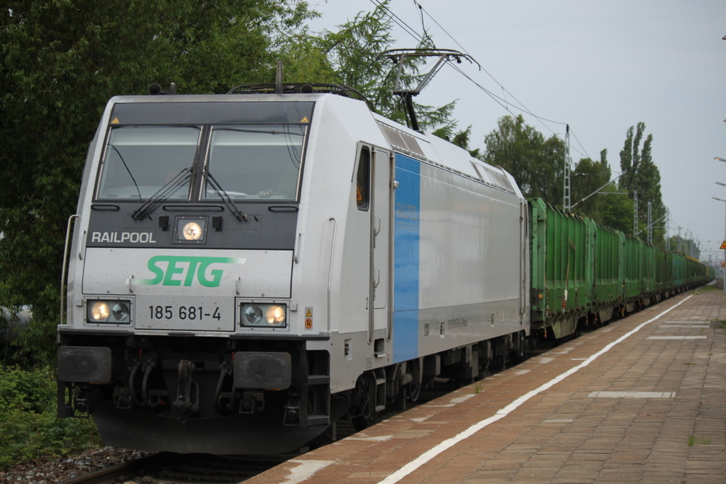 Railpool 185 681-4 SETG  mit Holzzug von Rostock-Bramow nach Stendal-Niedergrne bei der Durchfahrt im Haltepunkt Rostock-Holbeinplatz.28.05.2015