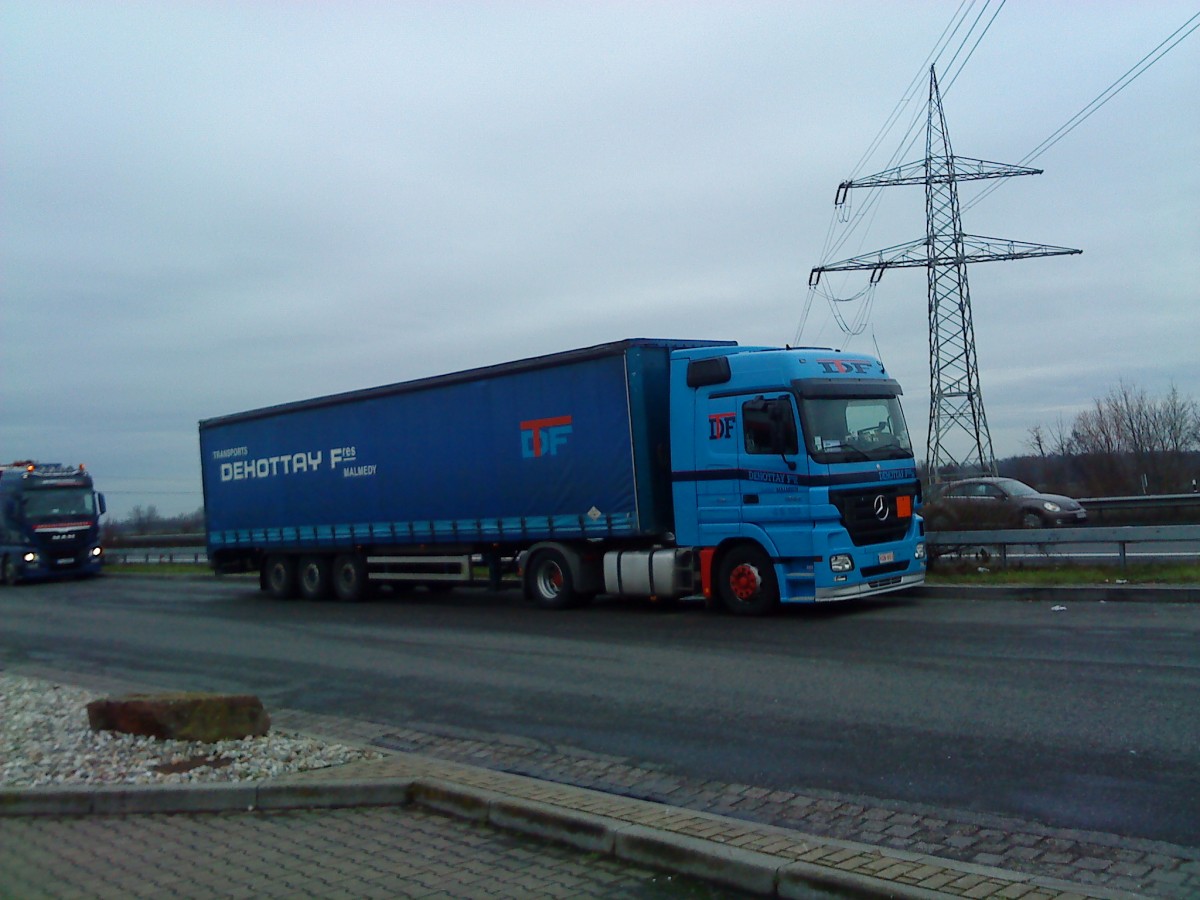 SZM Mercedes-Benz Actros 1844 mit Pritsche-Planen-Auflieger der Spedition TDF gesehen auf dem Parkplatz der Raststtte Dannstadt an der A 61, am 16.01.2014