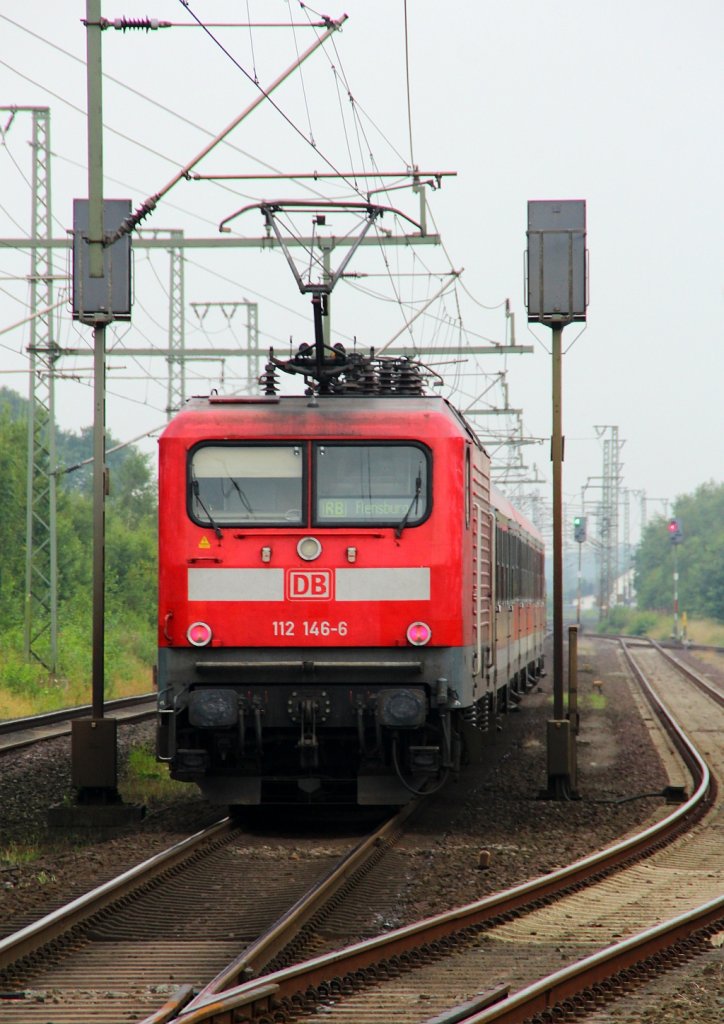 Wieder zurück aus Rostock ist die 112 146-6 die hier mit einer RB nach Flensburg den Bahnhof Jübek verlässt. 04.08.2012