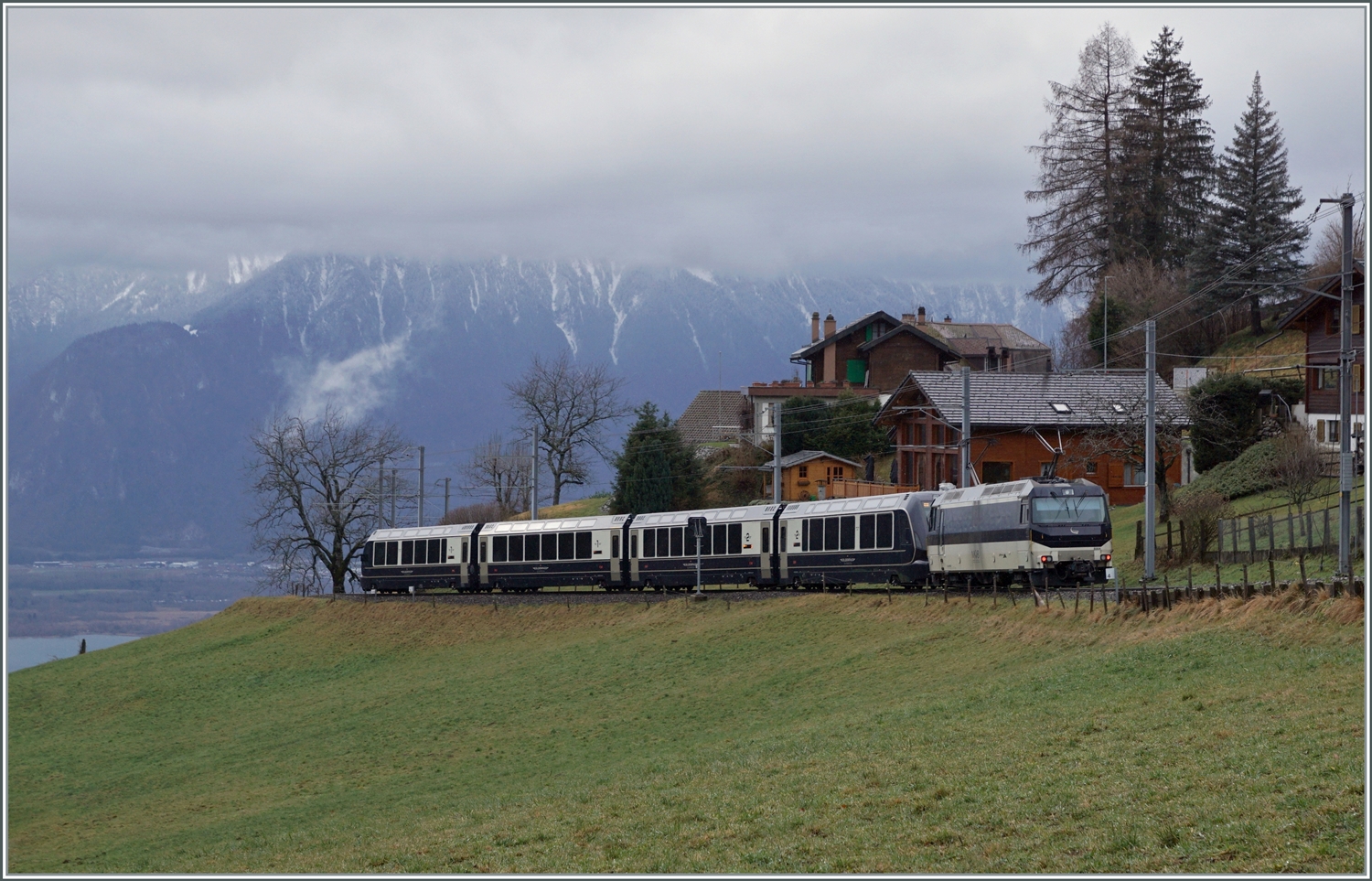 Kurz nach Les Avants ist die MOB Ge 4/4 8004 mit dem MOB/BLS GoldenPass Express GPX 4064 von Interlaken Ost nach Montreux unterwegs. Ganz Links im Bild ist der Genfersee zu sehen und somit der Höhenunterschied, welcher der GPX auf den noch verbleibenden zehn Kilometer bis Montreux zurück legen muss. 

6. Jan. 2024