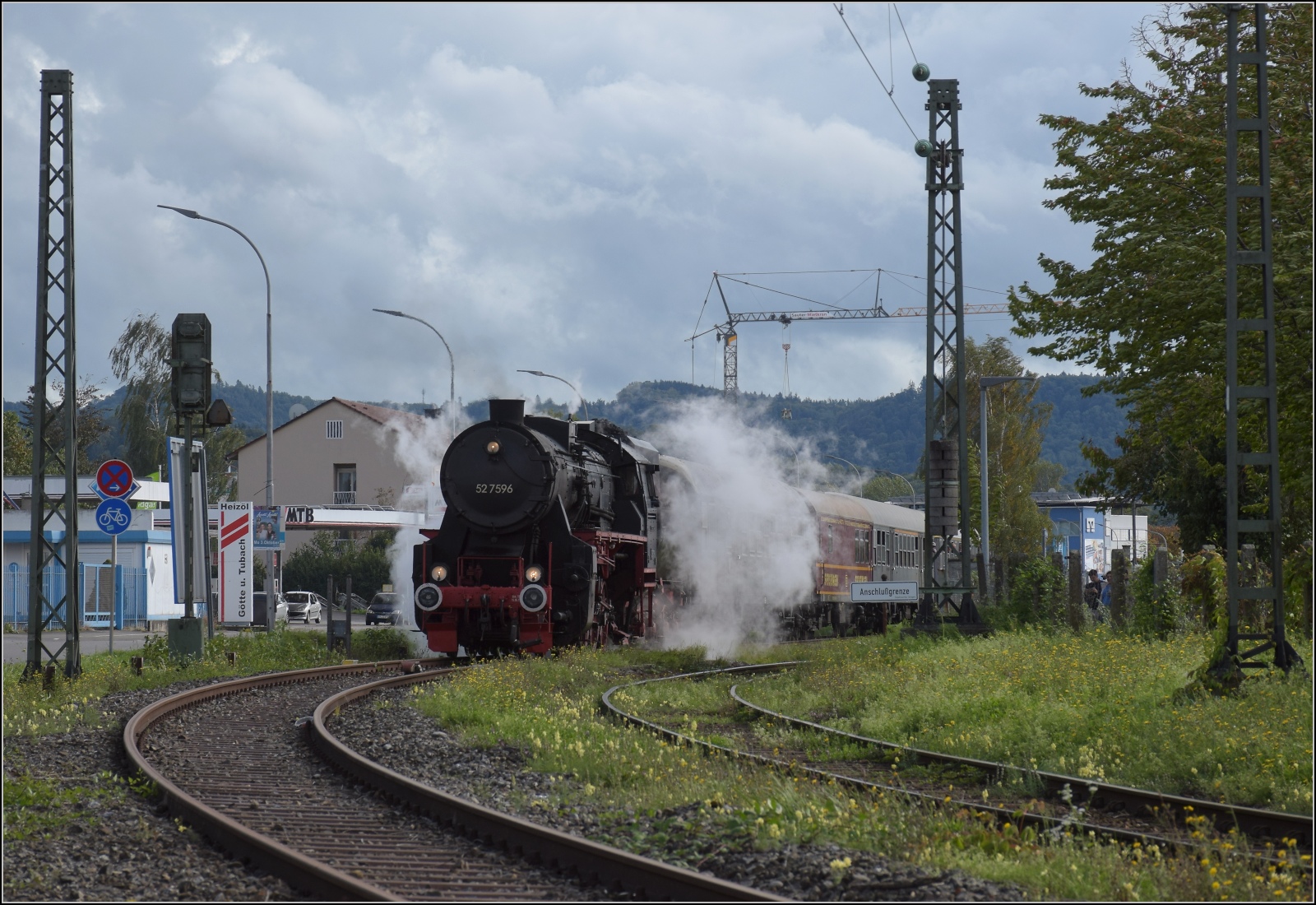 Schienenverkehr unterm Hohentwiel. 

52 7596 mit ihrem EFZ-Sonderzug für die SEHR & RS wartet am Einfahrtsignal des Bahnhof Singen, nachdem sie mir beim letzten Bahnübergang Ostendstrasse entwischt war. Oktober 2022.