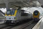 E-Lok 1812 ist mit ihrem Zug in den Bahnhof von Lüttich eingefahren, daneben steht ein M7 Triebzug. 10.07.2025 E-Lok 1812 ist mit ihrem Zug in den Bahnhof von Lüttich eingefahren, daneben steht ein M7 Triebzug. 10.07.2025