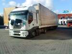 SZM IVECO Stralis mit Pritsche-Planen-Auflieger auf dem Autohof in Grnstadt am 11.11.2013