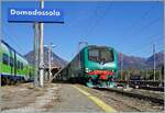 Die Trenord E 464 122 wartet mit einem Regionalzug in Domodossola auf die Abfahrt in Richtung Milano.

28. Okt. 2021