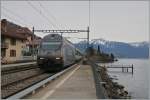 Die SBB Re 460 107-6 wirbt für den Gotthard Basis Tunnel, hier mit einem IR bei der Durchfahrt in St-Saphorin.